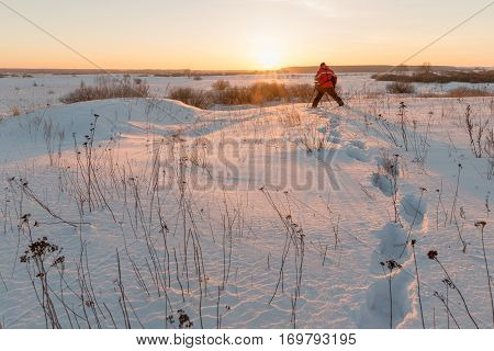 photographer takes winter landscape at dawn in the bitter cold.
