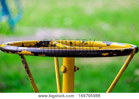 Part of old carousel for children 4 seats in the playground front focus blurred background