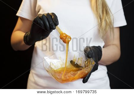 Woman With Sugar Hair Removing Paste On Dark Background