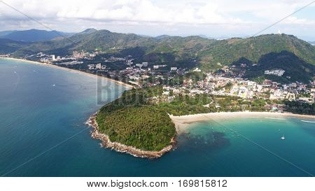 Aerial view of small island, long tail boats on the sea near Kata beach in Phuket, Thailand