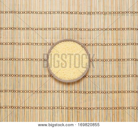 Plate with bath salt on bamboo mat. Health, treatment, spa concept.