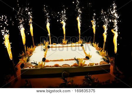 Rectangular Birthday fruit cake with fireworks candles