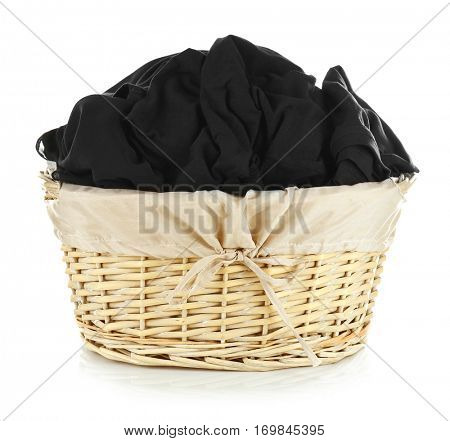 Clothes in wicker basket on white background