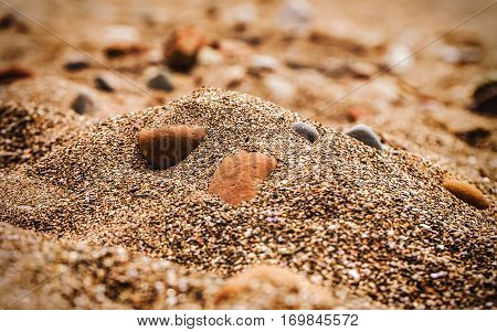 Gravel sand and stones on the golden beach