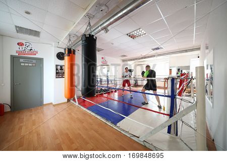 MOSCOW - MAR 25, 2016: Two man fight in modern gym New Sparta with boxing ring, In addition to standard set of fitness services New Sparta offers classes with champion - highly qualified trainers