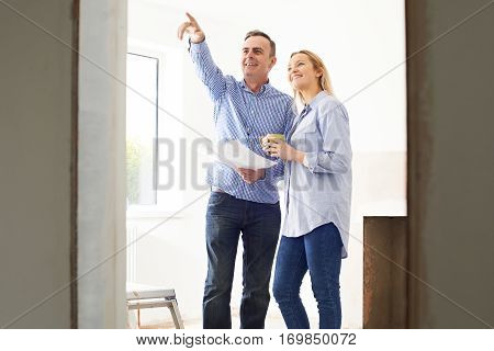 Woman Meeting With Architect Or Builder In Rennovated Property
