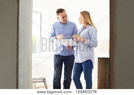 Woman Meeting With Architect Or Builder In Rennovated Property
