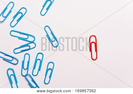 Undaunted red paperclip. Miscellaneous office supplies. Assortment of stationery.