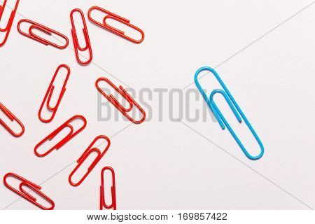Undaunted blue paperclip. Miscellaneous office supplies. Assortment of stationery.