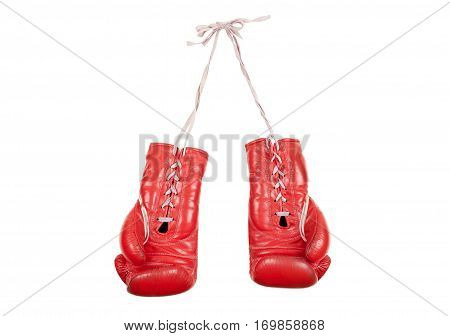 old used and battered red leather boxing gloves isolated on white background