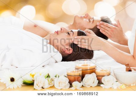 Close-up Of A Young Couple Receiving Head Massage At Beauty Spa