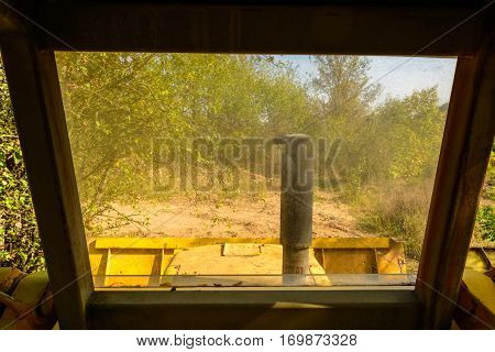 Old bulldozer forgotten in the mine. Big yellow rusted excavator.