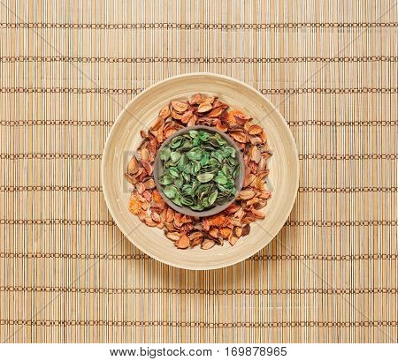 Plate with aroma petals on bamboo mat. Spa, beauty, treatment concept. 