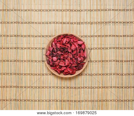 Plate with aroma petals on bamboo mat. Spa, beauty, treatment concept. 