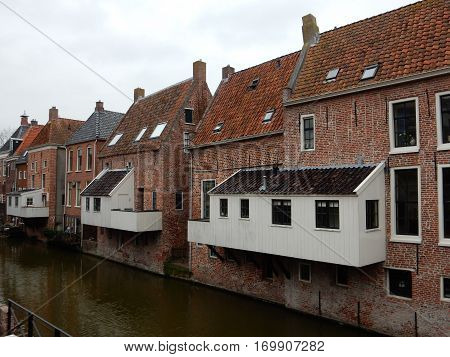 White kitchens above the water in old town Appingedam
