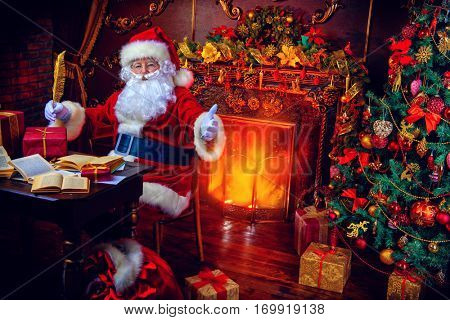 Christmas, mail of Santa Claus. Santa Claus at his home beautifully decorated for Christmas reading letters and making plans of travelling around the planet. Christmas time. Time for miracles.