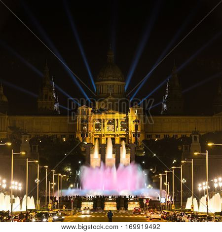 Barcelona Spain - January 06 2017: Large group of people looks at the musical fountain of Montjuic near the National Art Museum of Catalonia at night