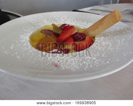 Zabaglione cream with fresh fruit and rolled wafer