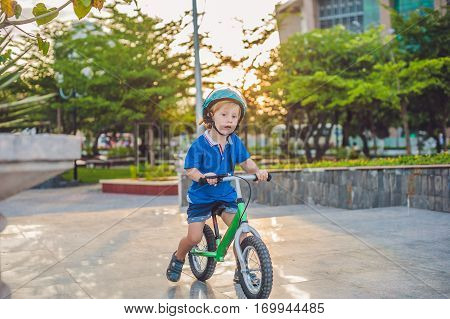 Active Blond Kid Boy Driving Bicycle In The Park Near The Sea. Toddler Child Dreaming And Having Fun