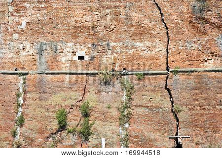 Cracked brick wall - Deep crack in a brick wall