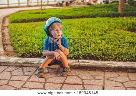Boy Playing On The Playground In The Background Of Green Grass