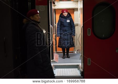 A Woman Train Conductor Standing On The Platform