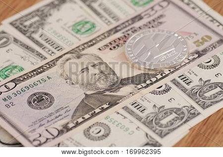 SARANSK, RUSSIA - FEBRUARY 5, 2017: Silver plated Litecoin on United States fifty-dollar billl.