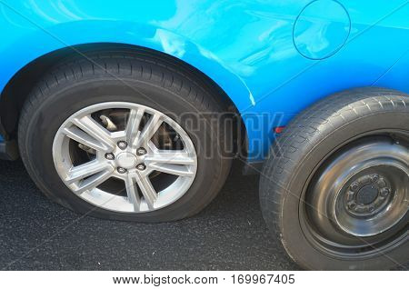 Flat tire on car, replacing with spare dummy 