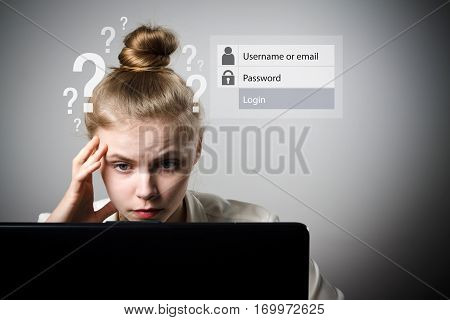 Young slim woman is using a laptop to browse the net. Forgot password concept.