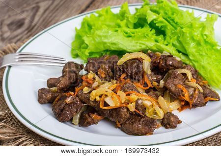 Calfs liver with letucce garnish. Studio Photo