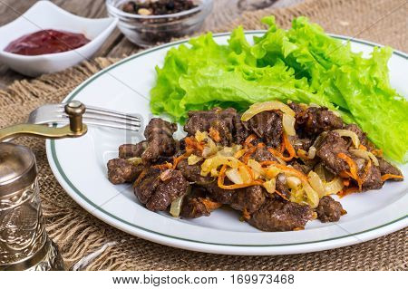 Calfs liver with letucce garnish. Studio Photo