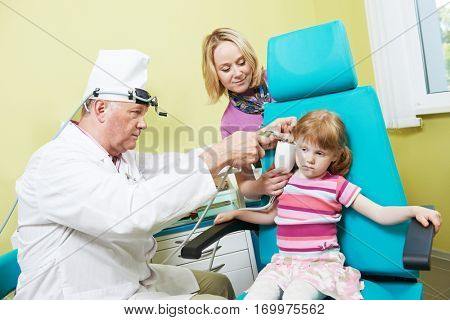 Little girl at ear nose thoat doctor examination