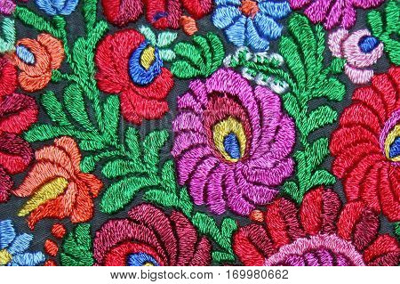 Multicolor floral hand embroidery pattern macro image