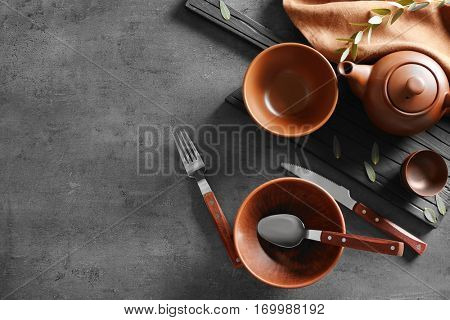 Set of dishes and cutlery on gray background,top view