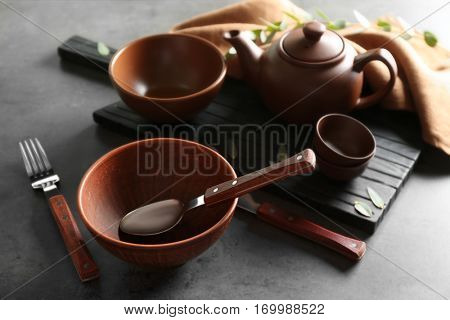 Set of dishes and cutlery on gray background