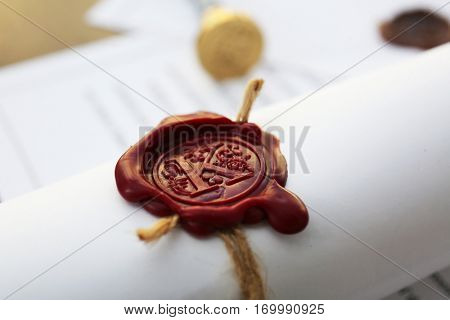 Old notarial wax seal on tied scroll, closeup
