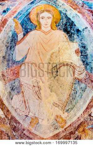 Christ pantocrator sitting on the rainbow, a romanesque wall-painting in ultramarine at Asum church Sweden - May 12 2014