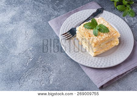 Layered Cake With Cream Napoleon Millefeuille Vanilla Slice With Mint On Dark Background.