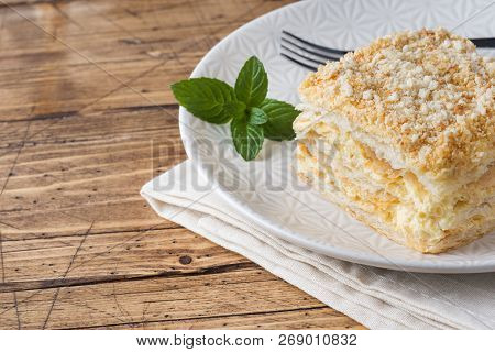 Layered Cake With Cream Napoleon Millefeuille Vanilla Slice With Mint On Wooden Background.
