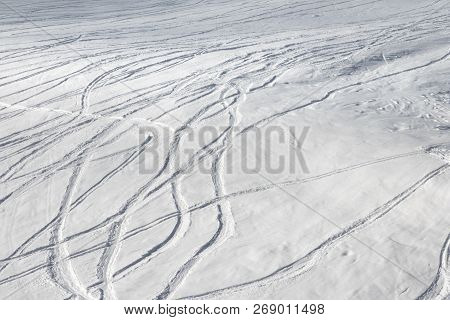 Snowy Off-piste Ski Slope With Trace From Skis And Snowboards At Sun Winter Day