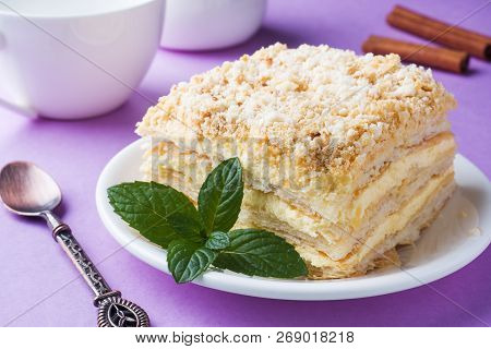 Puff Cake With Cream Napoleon Millefeuille Vanilla Slice With Mint Color On Purple Background.