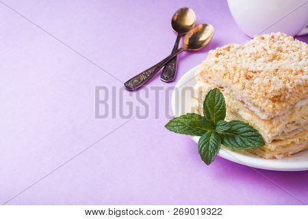 Puff Cake With Cream Napoleon Millefeuille Vanilla Slice With Mint Color On Purple Background.