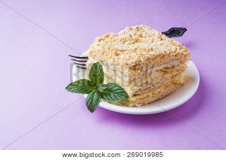 Puff Cake With Cream Napoleon Millefeuille Vanilla Slice With Mint Color On Purple Background.