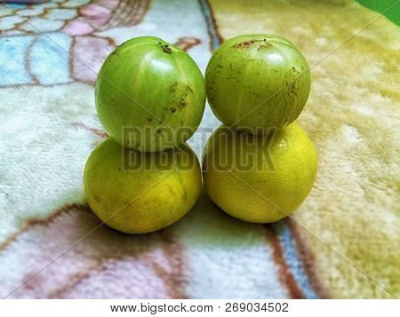 Two Gooseberry On The Top Of Lemon