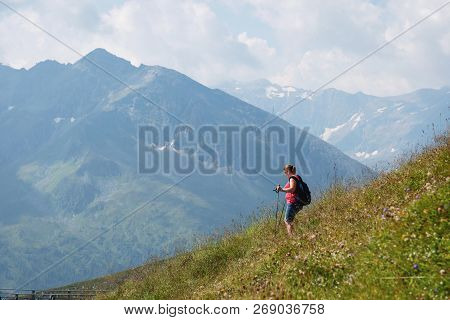 Bad Gastein, Austria - August 06, 2018: Female Hiker Hiking Down Alpine Hills With Nails.