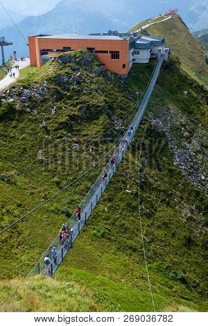 Bad Gastein, Austria - August 06, 2018: People Cross A Suspension Bridge On The Stubnerkogel, Gastei
