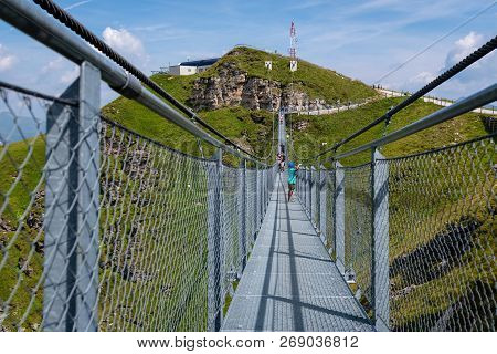 Bad Gastein, Austria - August 06, 2018: People Cross A Suspension Bridge On The Stubnerkogel, Gastei