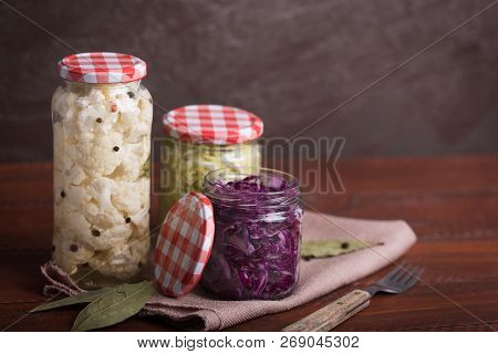 Sauerkraut In A Blue Bowl On A Wooden Table. Copy Space