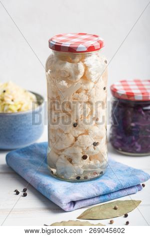 Fermented Cauliflower In A Jar On A Wooden Table