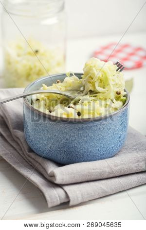 Sauerkraut In A Blue Bowl On A Wooden Table